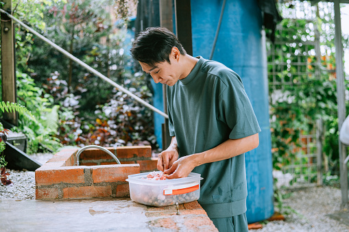 Young Asian Chinese father preparing for barbecue