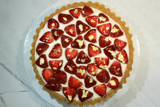 istock strawberry pie with cream and strawberries as a topping on white plate on the table table. delicious fruit pie. food photography concept. 1441859013