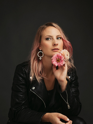 Beautiful woman with flowers studio shot