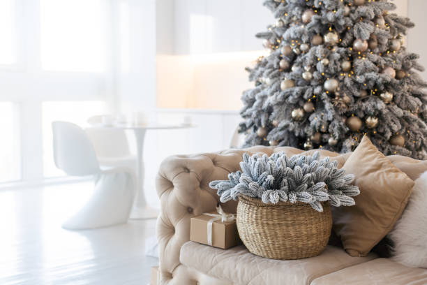 istock Classic white christmas interior with new year tree decorated. grey chair and presents under the tree 1441859838