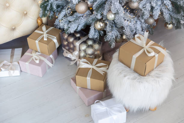 istock christmas and new year background - gift boxes near decorated christmas tree and copy space 1441860761