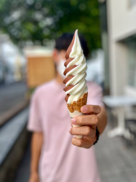 istock person holding ice cream 1441862786