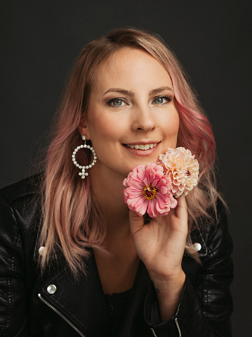 Beautiful woman with flowers studio shot