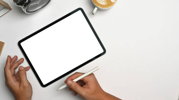 istock Above view of man holding stylus pen, using digital tablet on white office desk. 1441864680