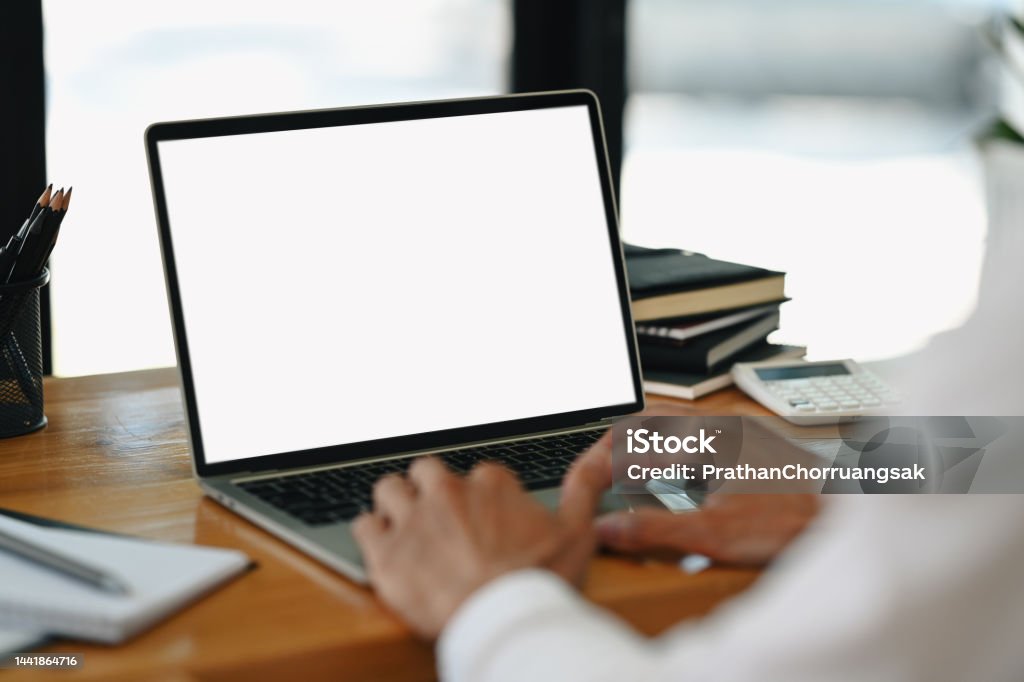 Close up view of businessman hands typing on laptop, working online from home. Blank screen for your advertise text. Computer Monitor Stock Photo