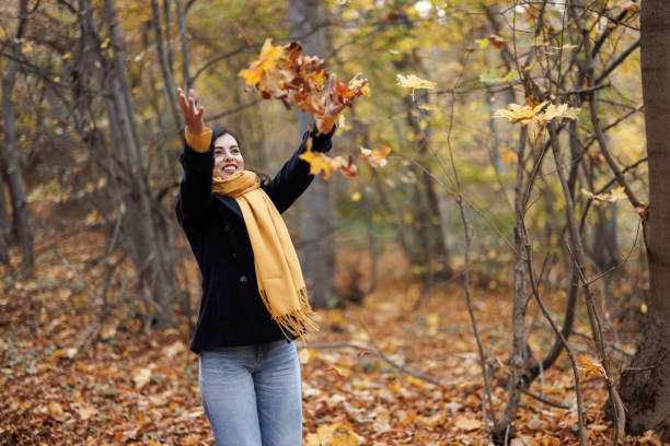 istock Playful woman in autumn forest 1441866687