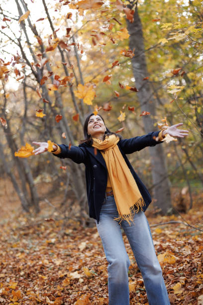 istock Playful woman in autumn forest 1441866929