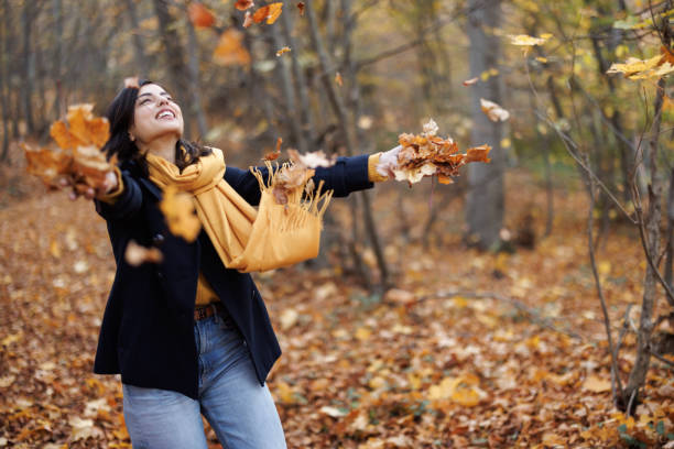 istock Playful woman in autumn forest 1441867183