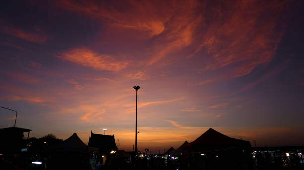 istock Dramatic sky with silhouette of night market 1441867302