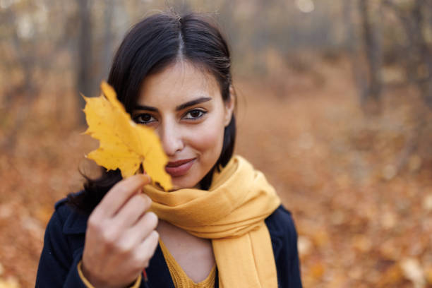 istock Beautiful woman holding a leaf 1441868258