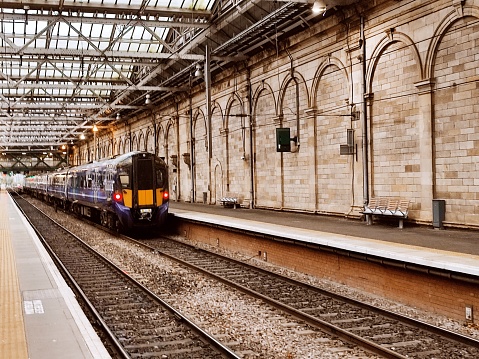 Train is coming to station on railway at edinburgh scotland england uk