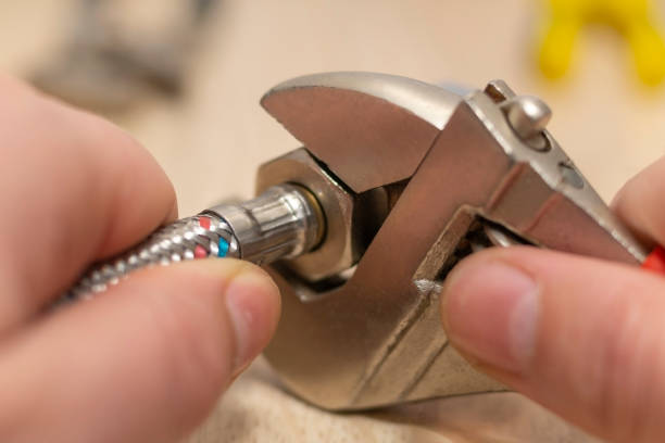 istock Closeup on flexible water supply tubes and adjustable wrench. 1441870641