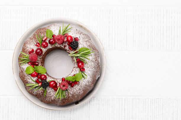 istock Christmas cake with pomegranate seeds, cranberries and rosemary 1441870851