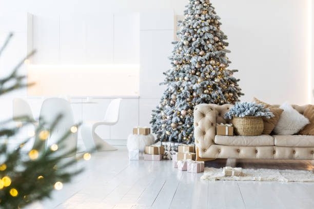 istock Classic white christmas interior with new year tree decorated. grey chair and presents under the tree 1441871933