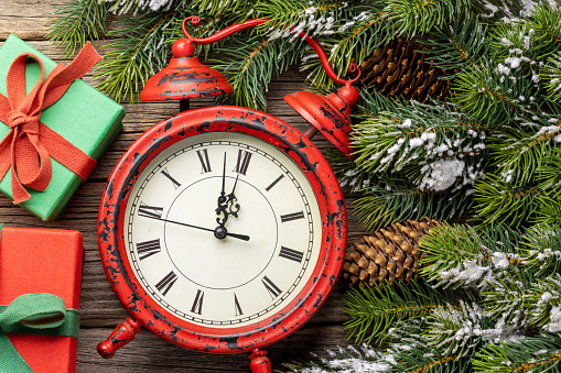 New Year alarm clock and fir tree. Christmas greeting card
