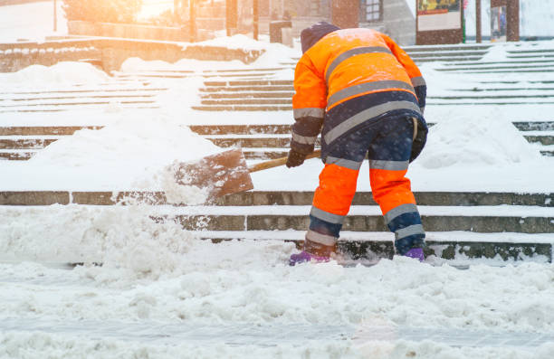 istock Snow removal. A worker cleans snow with a shovel after a snowfall at gatherings 1441872486