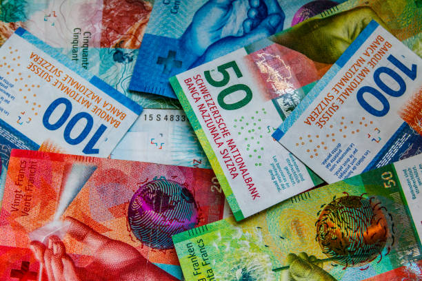 istock Background of the different swiss francs banknotes 1441873219