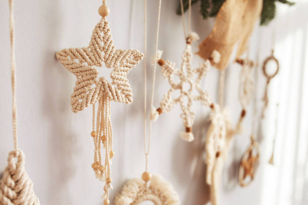 istock Christmas macrame decor. Christmas toy from natural materials - cotton thread, wood beads and stick. Eco decorations, ornaments, hand made decor. Winter and New Year holidays. Closeup 1441875149