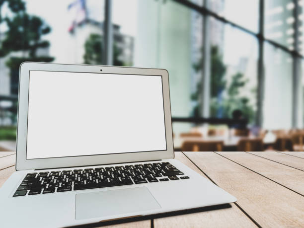 istock Laptop with blank screen on table in the coffee shop. 1441875647