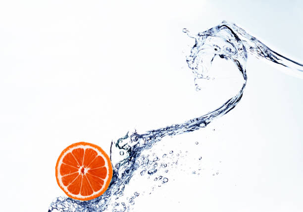 grapefruit in spray of water isolated on white  background