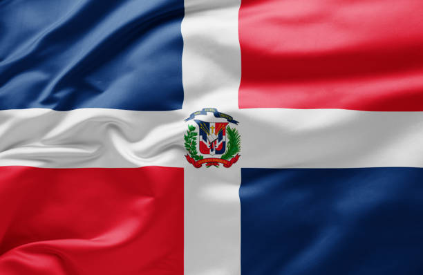 развевающийся государственный флаг доминиканской республики - dominican flag стоковые фото и изображения