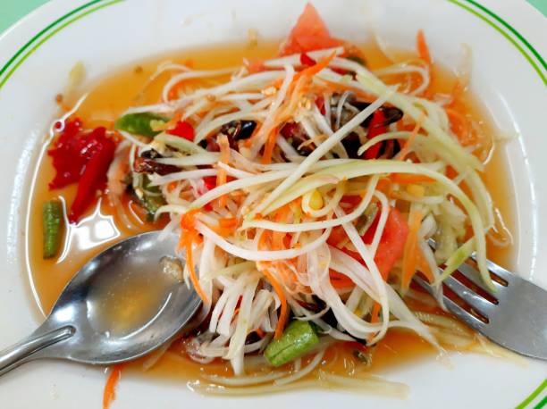Thai spicy green papaya salad - Som Tum. stock photo