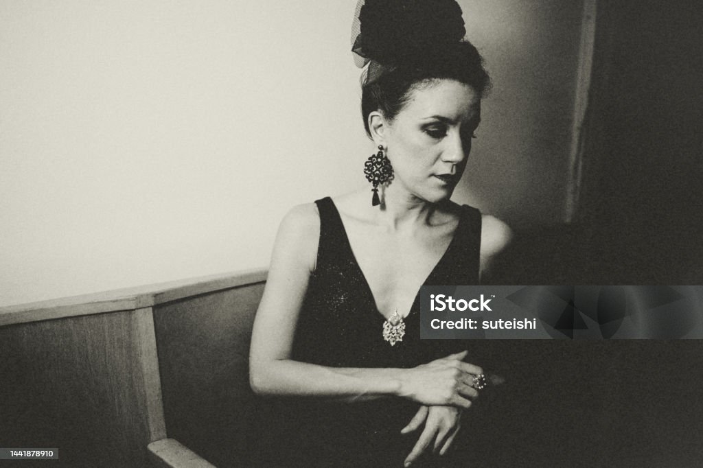 The female classical musician - Waiting for the performance. Portrait of a female musician. She is sitting backstage at an opera house waiting to perform. Singer Stock Photo