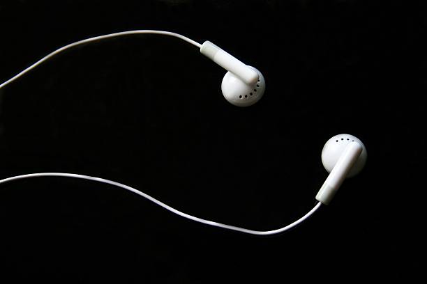 istock White earphones on a black background 144187908