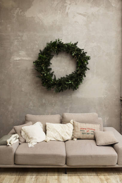 istock Modern living room interior with gray sofa and christmas wreath on wall 1441879730