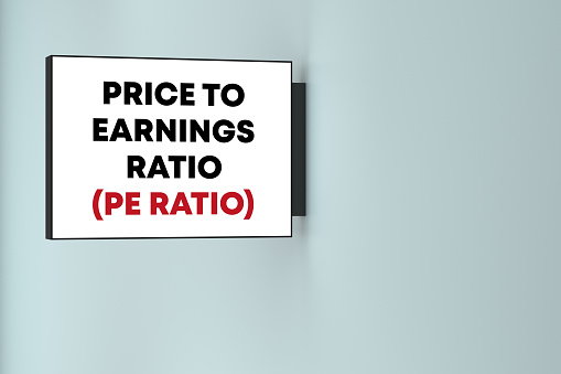 Price To Earning Ratio lettering on the lightbox on the wall. Business Terms Concept.