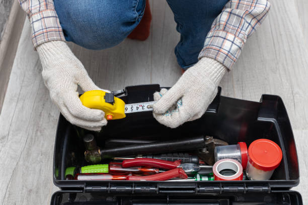a man takes a tape measure out of a toolbox a man takes a tape measure out of a toolbox. the master takes the tool out of the toolbox. roulette in hand handyman stock pictures, royalty-free photos & images