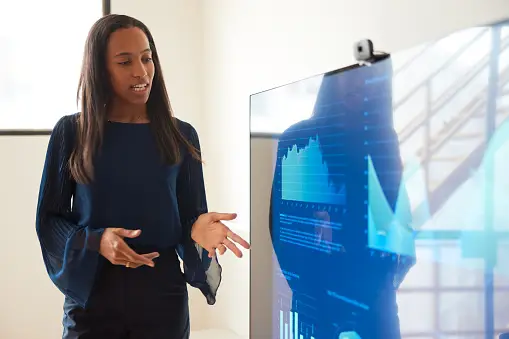 Tall attractive black businesswoman imparts information at business presentation images heavy presentation