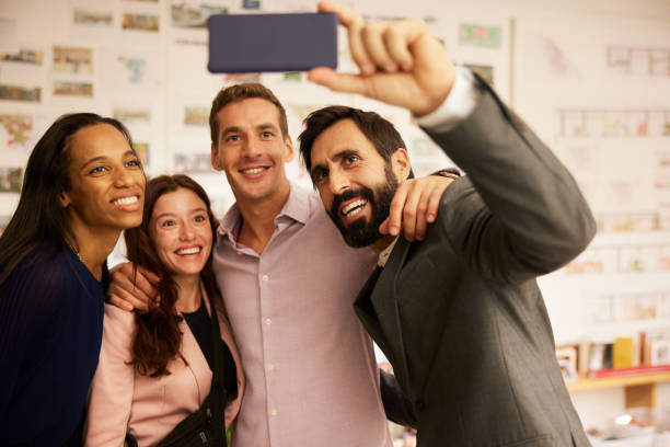 istock A multiracial business work team comes together to take a smiling selfie 1441882981