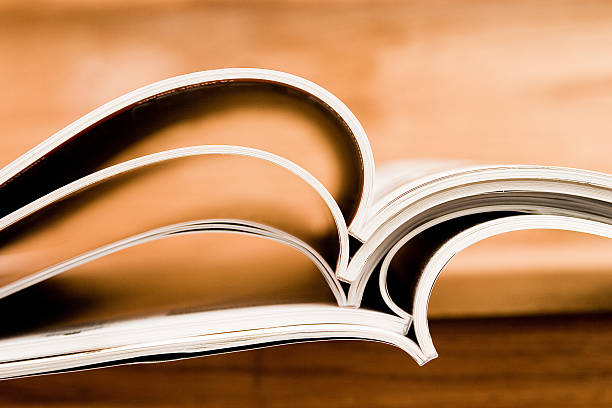 istock Several thin books stacked together and laying open 144188304