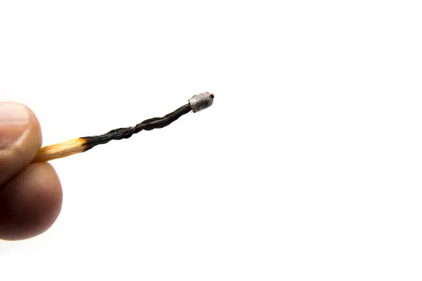 istock Burnt match stick in the hand on a white 1441883517
