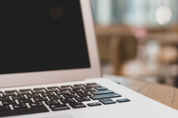 istock Laptop with blank screen on table in the coffee shop. 1441884521