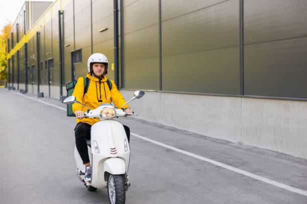 istock Delivery person on scooter while delivering orders in the city 1441884761