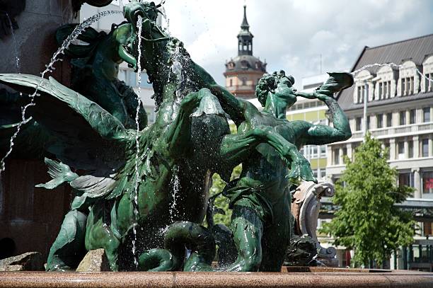 Neustadt an der Weinstrasse, Germany - August 2022: Sculpture at 'Elwedritsche Brunnen' fountain. Elwedritsche, or Elwetritsche, are a mythical creature mix of chickens, ducks, geese, goblins and elves from Palatinate . Created by artist Prof. Gernot Rumpf