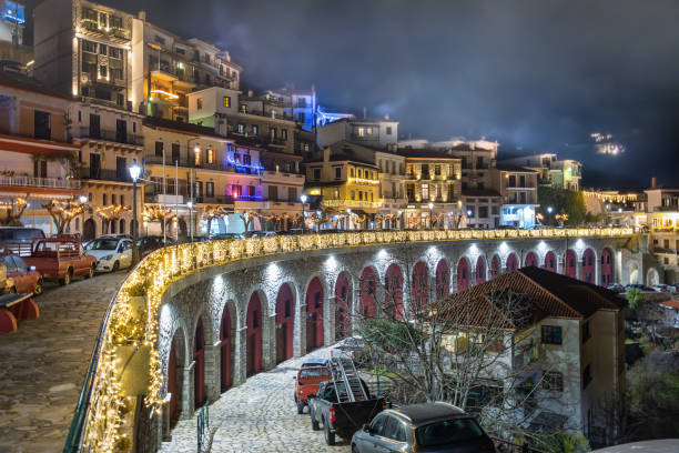 The village of Arachova, Greece, during winter night time The village of Arachova, Greece, next to the mountain Paranssus during a cold winter night with Christmas decoration lights arachova greece stock pictures, royalty-free photos & images