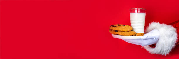 istock Hand of Santa Claus picking cookie 1441889728