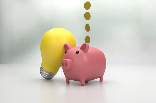 Piggy Bank And Light Bulb. Finance Concept.