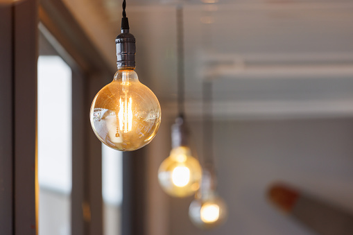 vintage light bulb hanging from ceiling for decoration in living room.