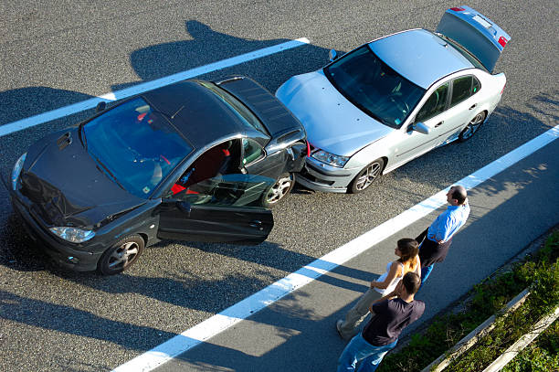 Fender Bender 5 Three people stand by the roadside after a small shunt on the freeway (motorway, autoroute, autobahn). car accident stock pictures, royalty-free photos & images