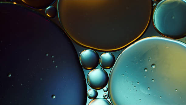 abstract colorful food oil drops bubbles and spheres flowing on water surface - tempera painting fotos imagens e fotografias de stock