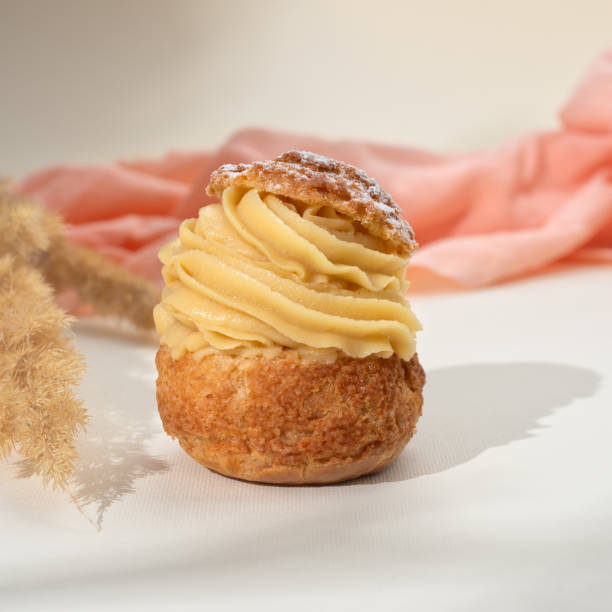 istock Summer desserts. Shu cake choux. Cake profiteroles with whipped cream. 1441899000