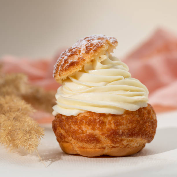 istock Summer desserts. Shu cake choux. Cake profiteroles with whipped cream. 1441899005