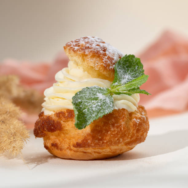 istock French dessert choux a la creme with whipped cream and mint. 1441899007