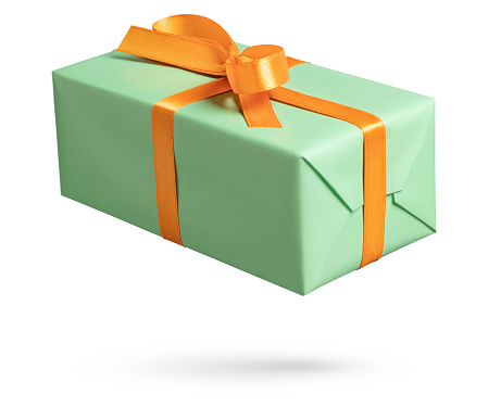 Green gift box with orange ribbon on white. This file is cleaned, retouched and contains clipping path.