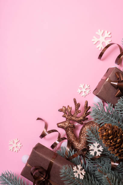 istock Pine trees branches with Cristmas New Year decoration top view, flat lay on pink background with copy space. Blank greeting card 1441900516