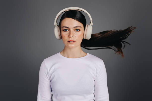 ritratto di una giovane donna che ascolta una playlist audio in cuffia - spanish culture audio foto e immagini stock